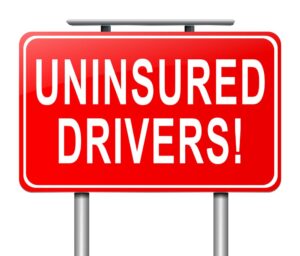 Uninsured Drivers sign board in red color