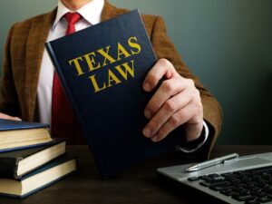 The lawyer offers a book with Texas law.