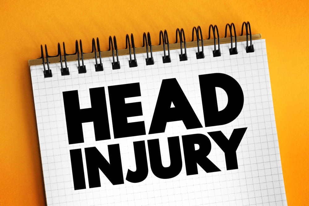 Notebook displaying the words “Head Injury,” symbolizing the process of evaluating head injury claim compensation.