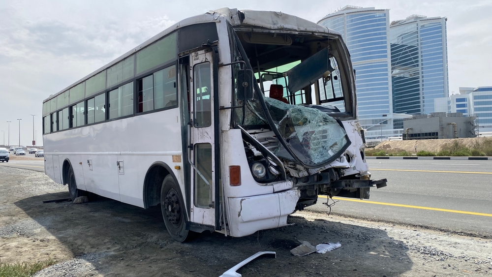 Crashed commercial bus with severe front-end damage on a Houston highway after a serious bus accident
