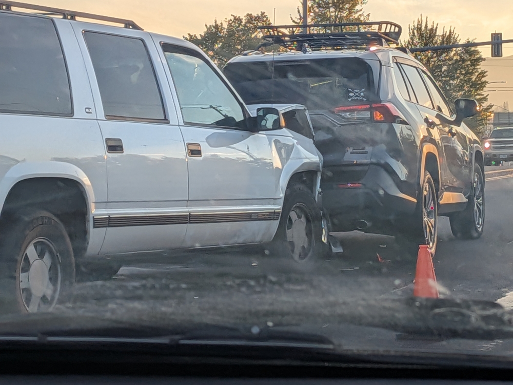 Rear-end collision involving two SUVs at a Houston intersection, showing significant rear and front-end damage